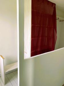 a red curtain on a cabinet in a room at La troglo aux oiseaux in Montrichard