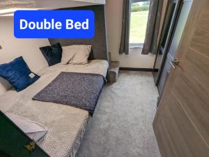 a bedroom with two beds and a double bed at Waterside Lodge - Stunning - Dog Friendly in Sutton on Sea