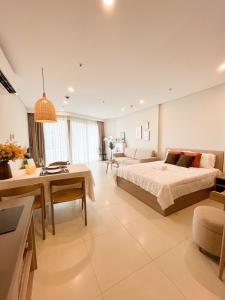 a large bedroom with a bed and a living room at The Song Luxury Apartment by Lisa House in Vung Tau