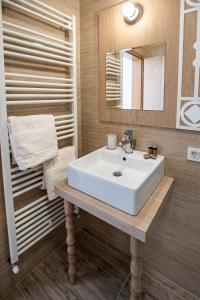 a bathroom with a white sink and a mirror at Monti Chalet in Poiana Brasov
