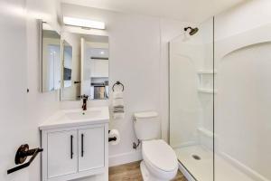 a white bathroom with a toilet and a shower at Stylish Studio Suite in West Oakland in Oakland