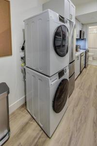 a kitchen with two washing machines stacked on top of each other at Luxury Studio Apt in Lake Merritt in Oakland