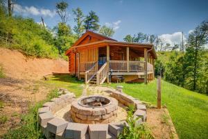 a log cabin with a fire pit in front of it at Life's A Bear in Gatlinburg