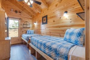 a bedroom with two beds in a log cabin at Life's A Bear in Gatlinburg