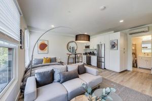 a living room with a couch and a kitchen at Private Luxury Studio in Lake Merritt in Oakland