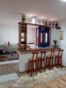 a kitchen with a table and four chairs at Solar dos Reis - Apartamento Turmalina in Ouro Preto