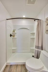a white bathroom with a toilet and a shower at Stylish Studio in Laney-Peralta in Oakland