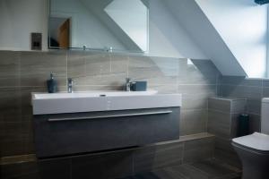 a bathroom with a sink and a toilet at Sam's Place Apartment in Uppingham, Rutland in Uppingham