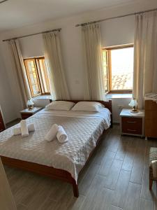 a bedroom with a bed with towels on it at Cozy Apartment in Drymades Village in Dhërmi