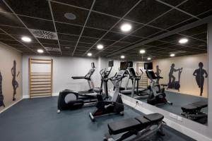 a gym with treadmills and elliptical machines at Catalonia Mirador des Port in Mahón