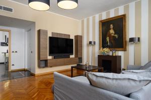 a living room with a couch and a flat screen tv at Happy Repubblica Milano in Milan