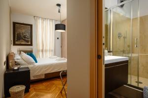 a bedroom with a bed and a sink and a shower at Happy Repubblica Milano in Milan