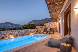 a villa with a swimming pool with mountains in the background at Sia Elafonisi Pool House in Elafonisi