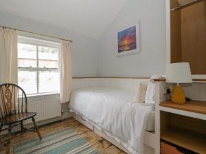 a bedroom with a bed and a window at Thyme Cottage in Great Malvern