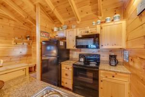 a kitchen with wooden cabinets and a stainless steel refrigerator at Always in Gatlinburg