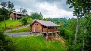 a log cabin on a hill with a house at Always in Gatlinburg