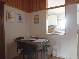a kitchen with a table and chairs in a room at Casa das Moitinhas in São Pedro do Sul
