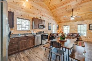 a kitchen with a table and a dining room at Bear Clubhouse Hot Tub, 1Mile from the Parkway, 900 in FREE Tickets! in Pigeon Forge