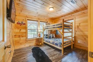 a bedroom with a bunk bed in a log cabin at Bear Clubhouse Hot Tub, 1Mile from the Parkway, 900 in FREE Tickets! in Pigeon Forge