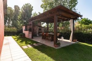un padiglione in legno con tavolo in cortile di Villa Luxury - Sarzana a Luni