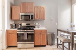 a kitchen with a stove and a microwave at The Matisse at Wooster Square Yale with Parking in New Haven