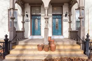 a house with blue doors and some pots on the stairs at The Matisse at Wooster Square Yale with Parking in New Haven