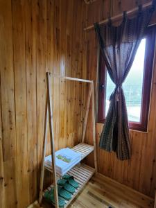 a room with a sauna with a window and a swing at THEN'S HOUSE Y TÝ in Phan Kơng Su