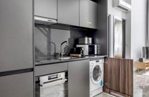 a kitchen with a sink and a washing machine at 2Bedroom apartment near Orchard RD! in Singapore