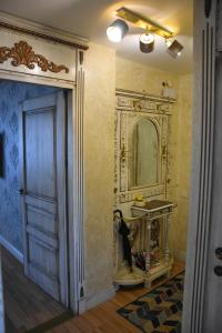 a bathroom with a mirror on the wall and a door at Provence apartment in Šiauliai