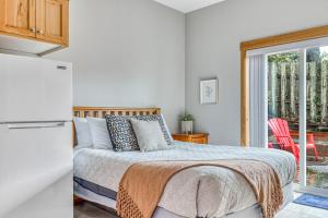 a bedroom with a bed and a door to a patio at Seaside Treasure in Seaside