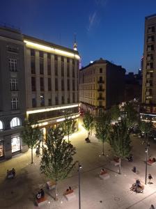 a city street with trees and buildings at night at Prywatny pokój dla dwóch osób Pokój 2 in Warsaw