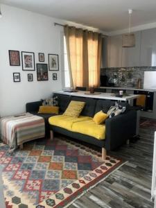 a living room with a couch and a table at Saint Mandé Paris in Saint-Mandé