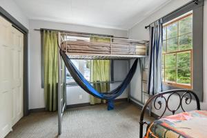 a bedroom with a bunk bed and a hammock in it at Hillsborough Village Retreat Walk to River! 