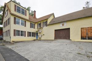 a large yellow house with a large garage at Hillsborough Village Retreat Walk to River! 