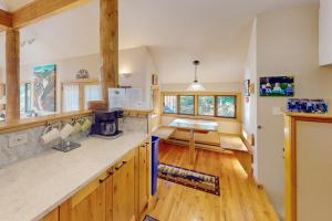 a kitchen with wooden cabinets and a counter top at Cool Ridge Town Home at Summerwood in Keystone