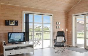 a living room with a television and a chair at Stunning Home In Skjern With Kitchen in Lem