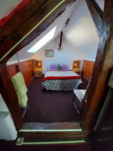 a bedroom with a bed in a attic at La CRAPOUNETTE in Pierry