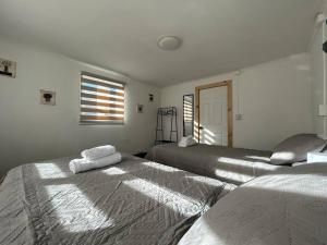 two beds sitting next to each other in a room at Downtown’s Sweet House in Puerto Natales