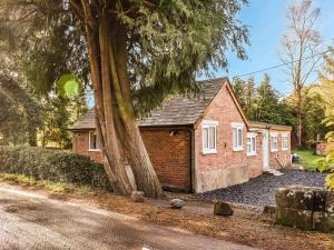 a small brick house sitting on the side of a road at Brookdale in Malpas