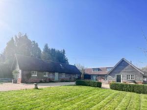 a house with a large lawn in front of it at The Old Stables 1 in Winterslow