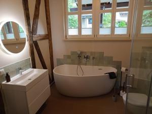 a bathroom with a tub and a toilet and a sink at Annel's Träumerei in Radebeul
