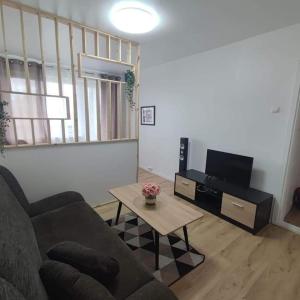 a living room with a couch and a coffee table at EVA Apartment Siauliai in Šiauliai