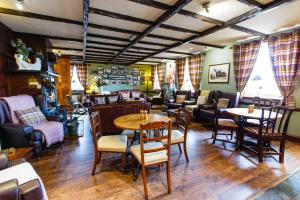 a restaurant with tables and chairs in a room at The Cock and Bull in Balmedie +33 photos