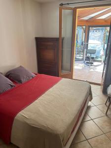 a bedroom with a bed and a sliding glass door at chez Guy in Marseille