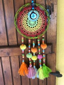 a colorful dream catcher hanging on a wall at chez Guy in Marseille