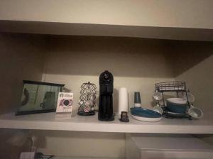 a shelf with a bunch of items on it at Suite 3 - Sweet Macon Home in Macon