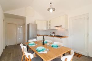 a kitchen and dining room with a wooden table and chairs at House Blato in Postira