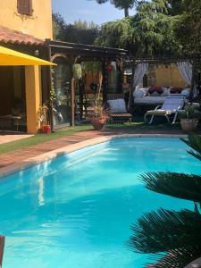 a swimming pool in a yard with a patio at chez Guy in Marseille