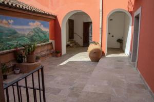 a corridor of a building with a painting on the wall at Palazzo Gentilizio de Maffutiis in Auletta