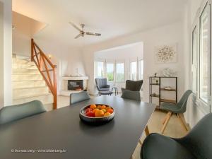 a dining room with a table with a bowl of oranges on it at Tapia Hills in Methoni